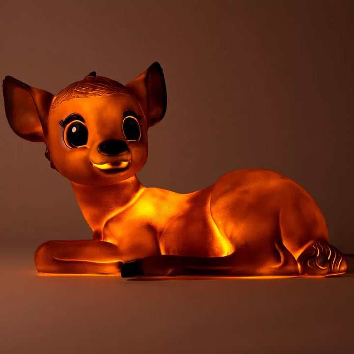 Egmont Toys lying fawn lamp glowing orange against a dark background