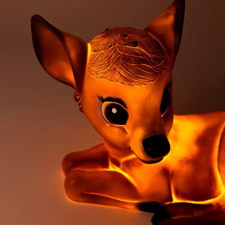 Close-up of the head and front legs of the illuminated Egmont Toys lying fawn lamp