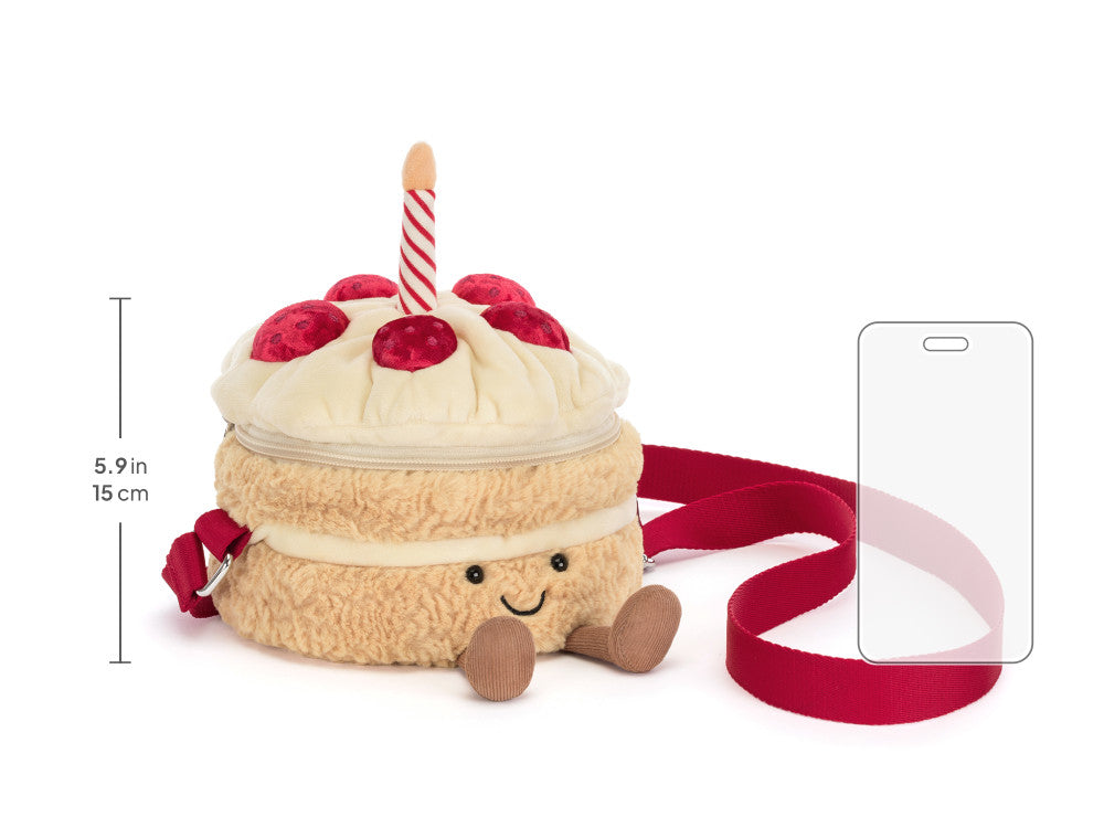 Jellycat Amuseables Birthday Cake Bag naast telefoon als formaatvergelijking