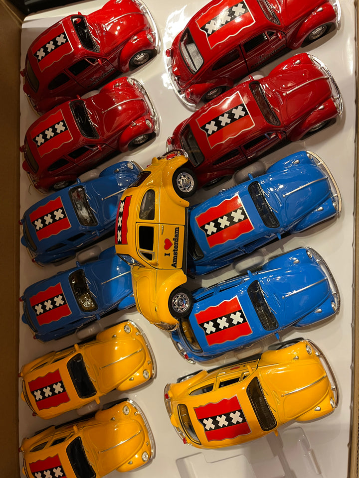 Welly Volkswagen Beetle I Love Amsterdam: overhead view of red, yellow and blue cars with Amsterdam crosses on the roof.