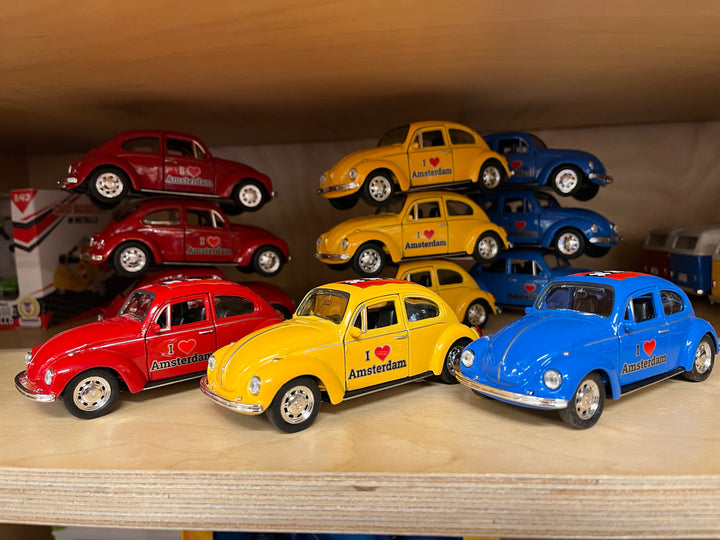 Welly Volkswagen Beetle I Love Amsterdam: red, yellow and blue miniature cars viewed from the front and side.