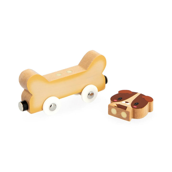 Holz-Hundefigur neben dem knochenförmigen Auto aus dem Janod Set magnetische Haustiere.