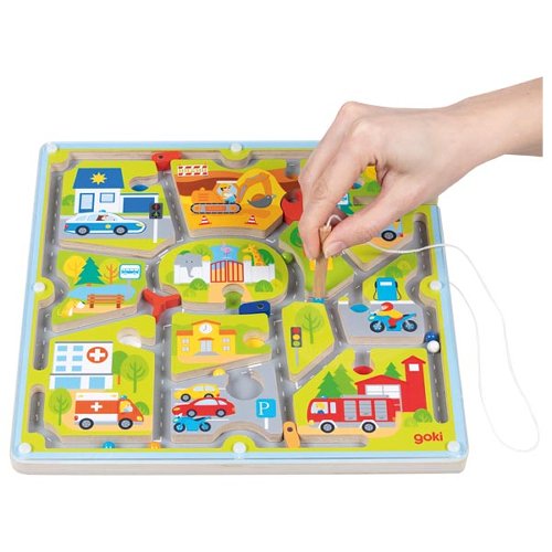 Child moving balls through the magnetic city maze