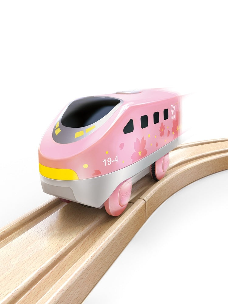 Roze Hape Intercity-locomotief op een houten treinspoor