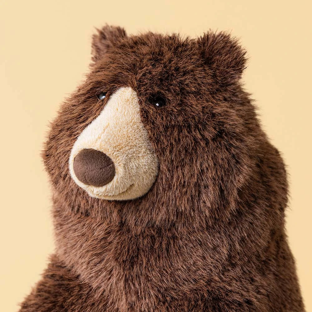 Detail of the head and soft brown fur of Jellycat Bizzlestomp Bear