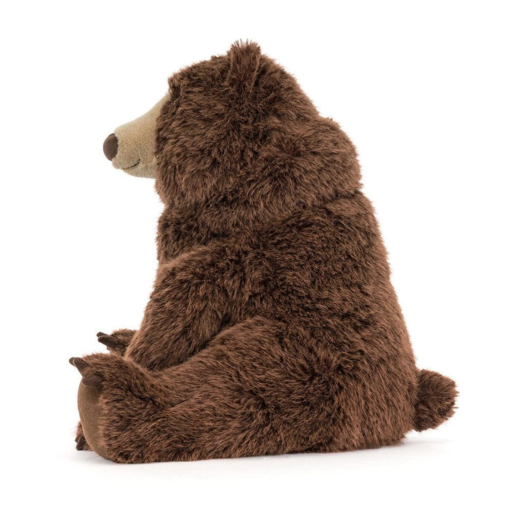 Side view of the seated Jellycat Bizzlestomp Bear