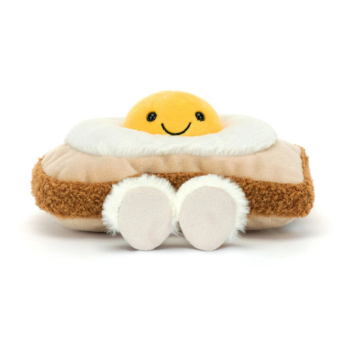 Jellycat Egglantine Egg On Toast direkt von vorn mit lächelndem Eigelb und zwei Hausschuhen