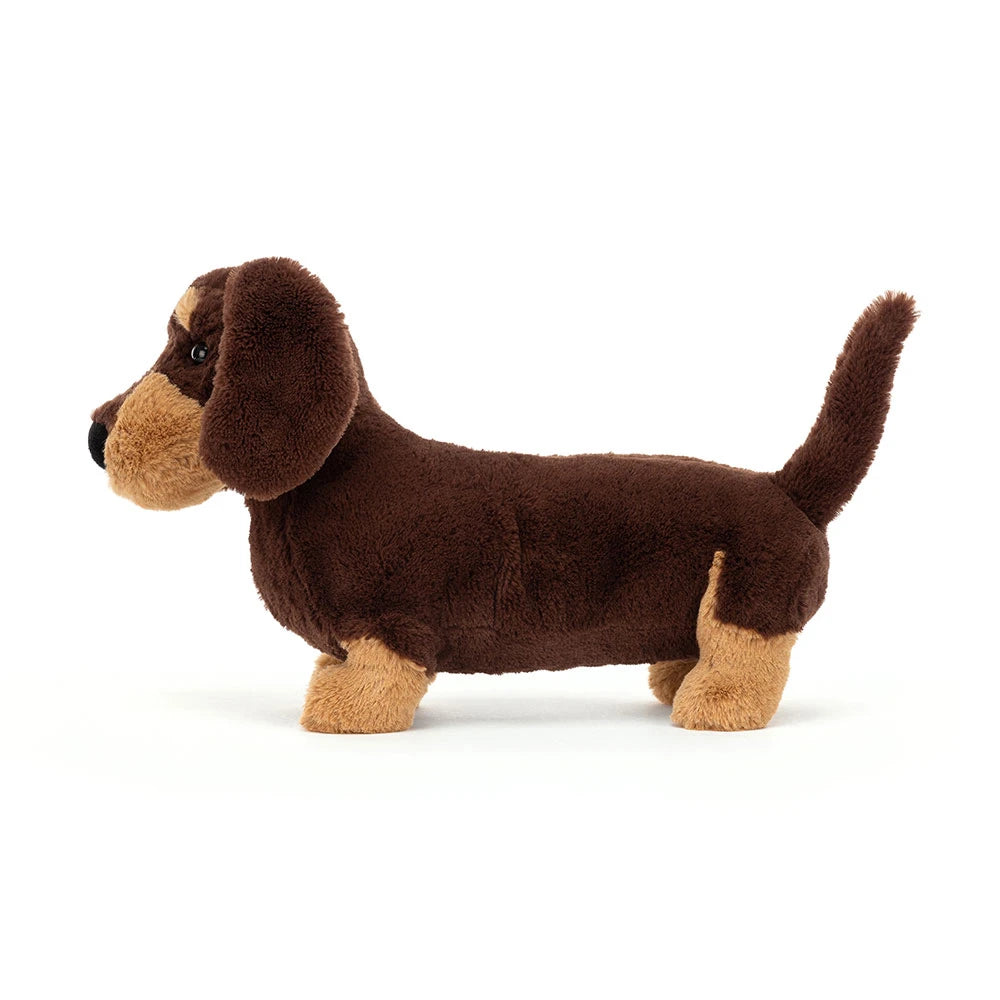 Side view of Jellycat Otto Sausage Dog Medium with a long body and upright tail