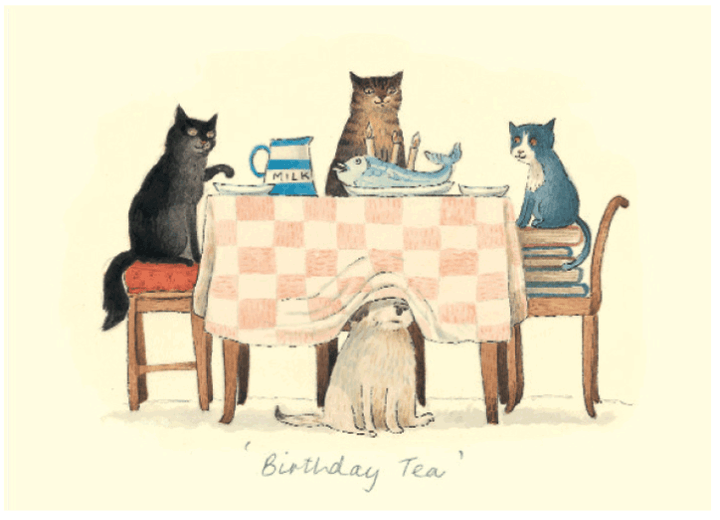 Cats sit around a table set with tea and a birthday cake.