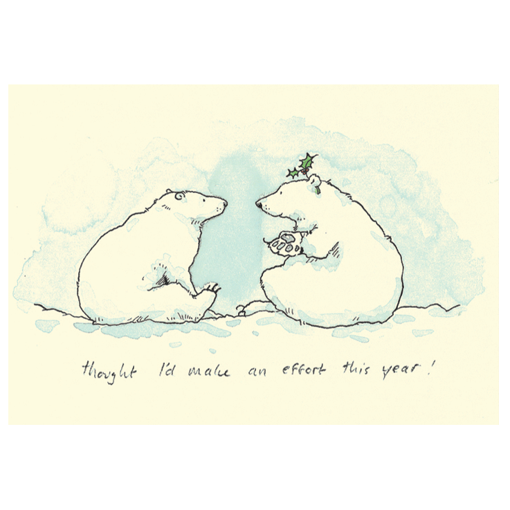 Two polar bears sit in the snow looking at each other.
